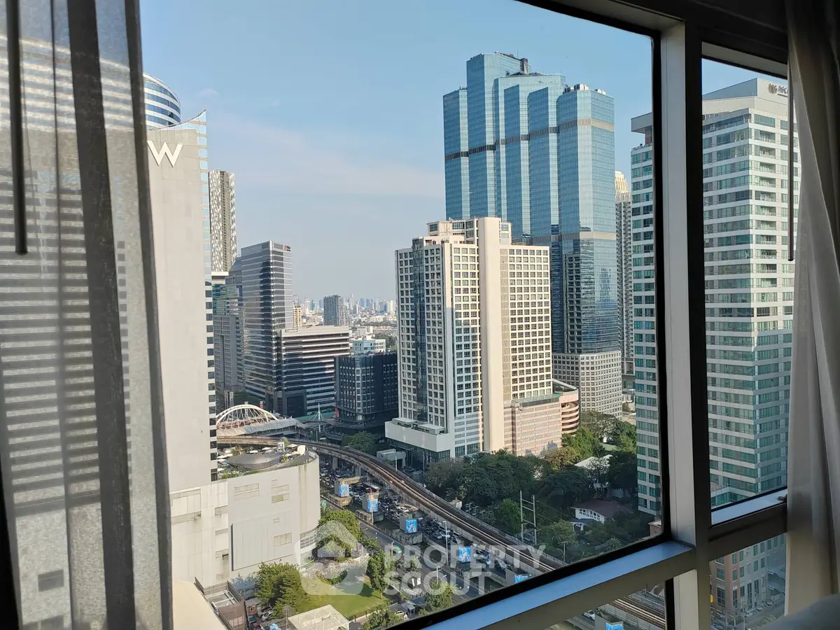 Stunning cityscape view from a high-rise apartment window showcasing modern skyscrapers and urban skyline.