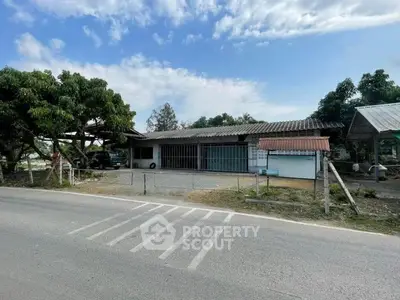 Charming rural property with spacious front yard and lush greenery, perfect for serene living or investment.