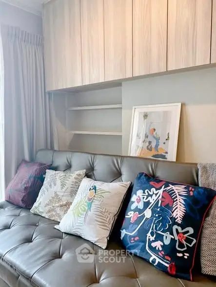 Stylish living room with modern decor and colorful cushions on a sleek sofa, perfect for cozy relaxation.