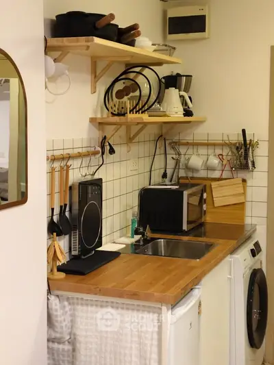 Charming kitchen with wooden countertops, modern appliances, and efficient storage solutions.