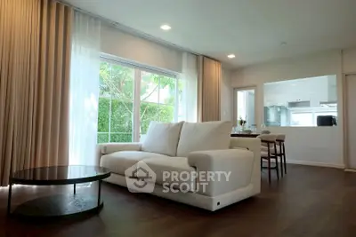 Spacious living room with modern decor and large windows offering natural light.