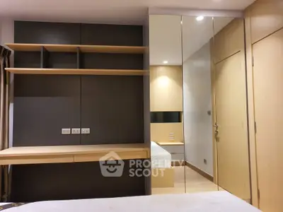 Modern bedroom with sleek built-in furniture and mirrored closet doors