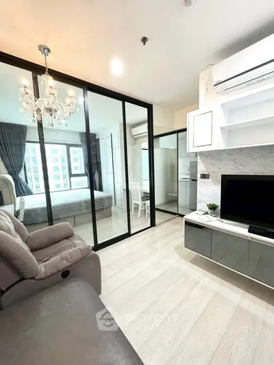 Modern apartment interior with glass partitions and elegant chandelier