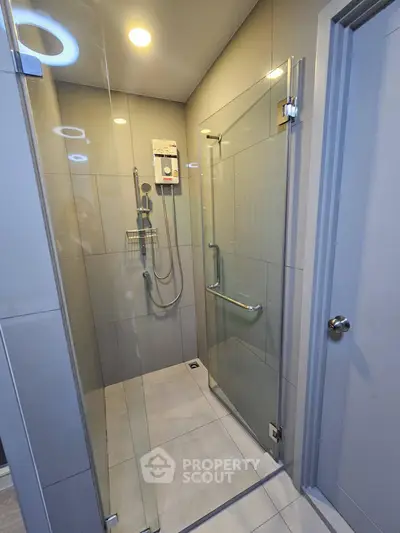 Modern bathroom with glass shower enclosure and sleek fixtures