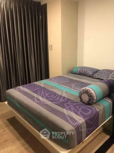 Cozy bedroom with modern decor and stylish bedding in a well-lit apartment.
