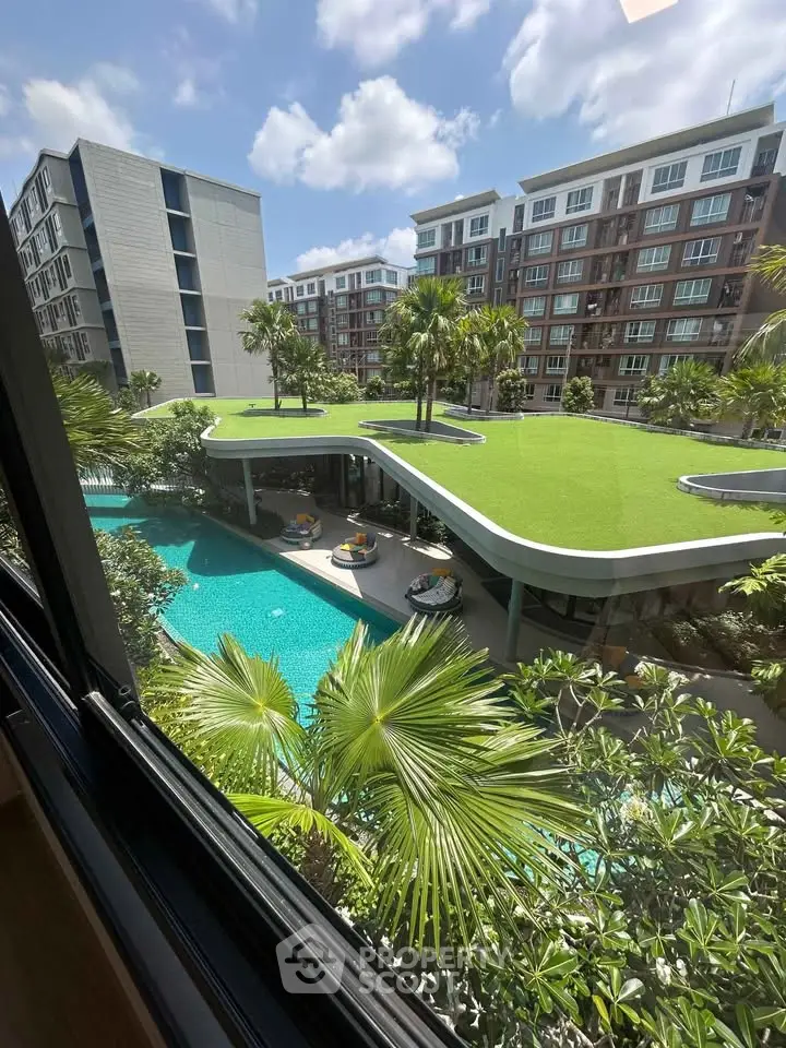 Luxurious apartment complex with stunning pool and lush greenery view.
