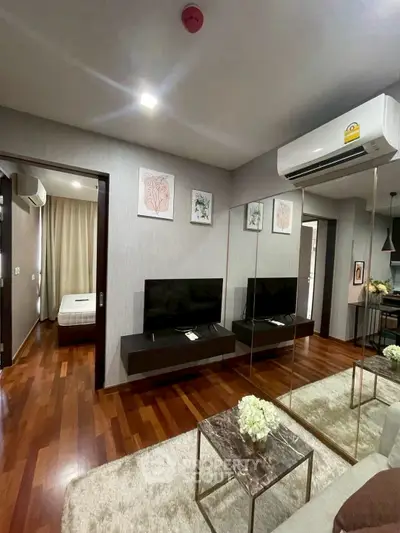 Modern living room with mirrored wall and hardwood floors