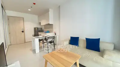 Modern living room with cozy sofa and open kitchen layout