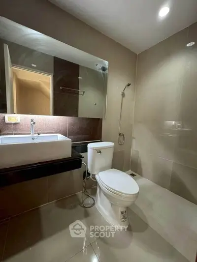 Modern bathroom with sleek fixtures and neutral tiles