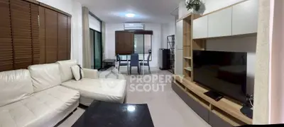 Modern living room with sleek furniture and large TV in a stylish apartment