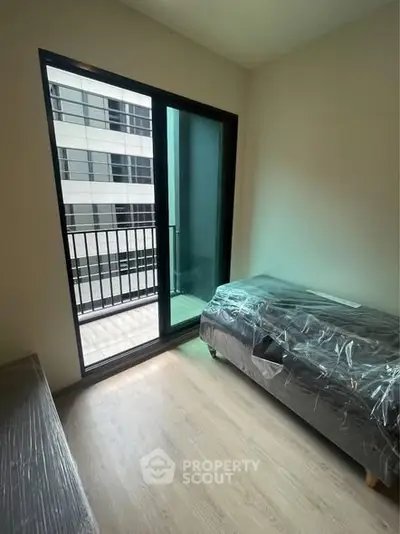 Modern apartment bedroom with balcony access and natural light