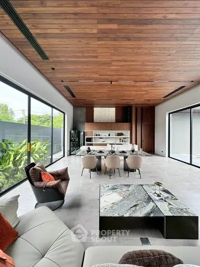 Luxurious open-plan living room with modern kitchen and stunning wooden ceiling