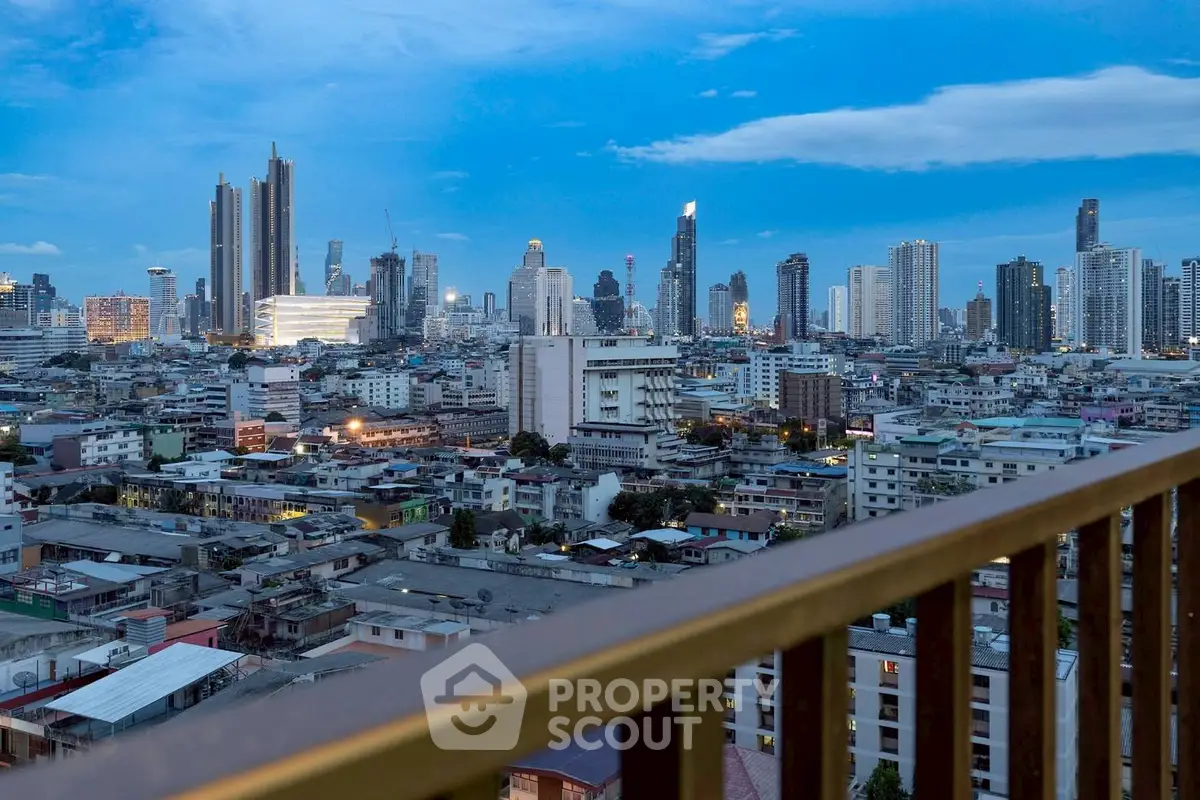 Stunning cityscape view from a high-rise balcony showcasing urban skyline at dusk.