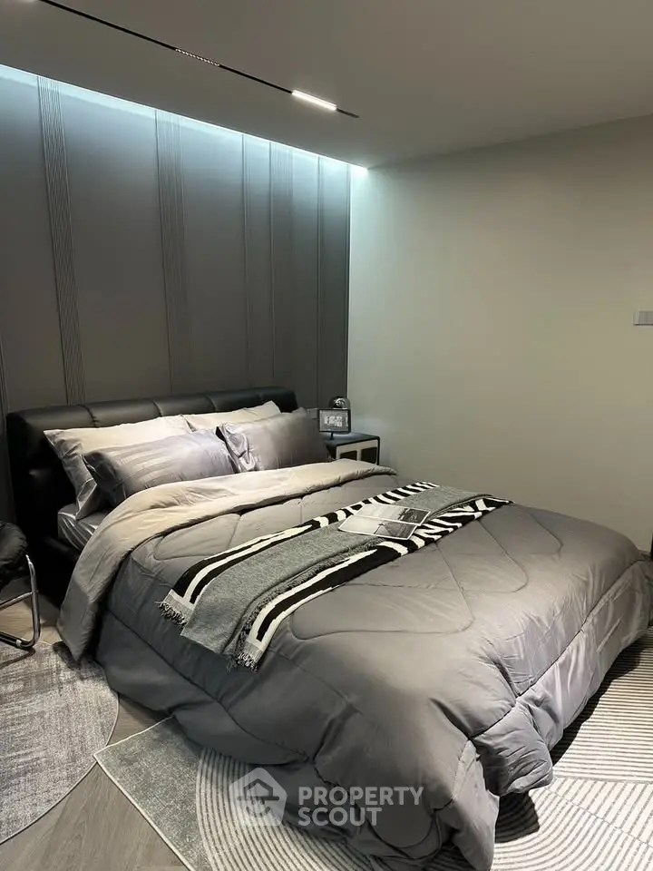 Modern bedroom with stylish decor and cozy bedding