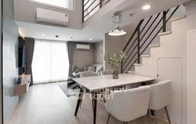 Modern duplex living room with stylish furniture and elegant staircase