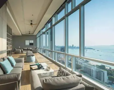 Luxurious high-rise living room with panoramic ocean views and modern decor.