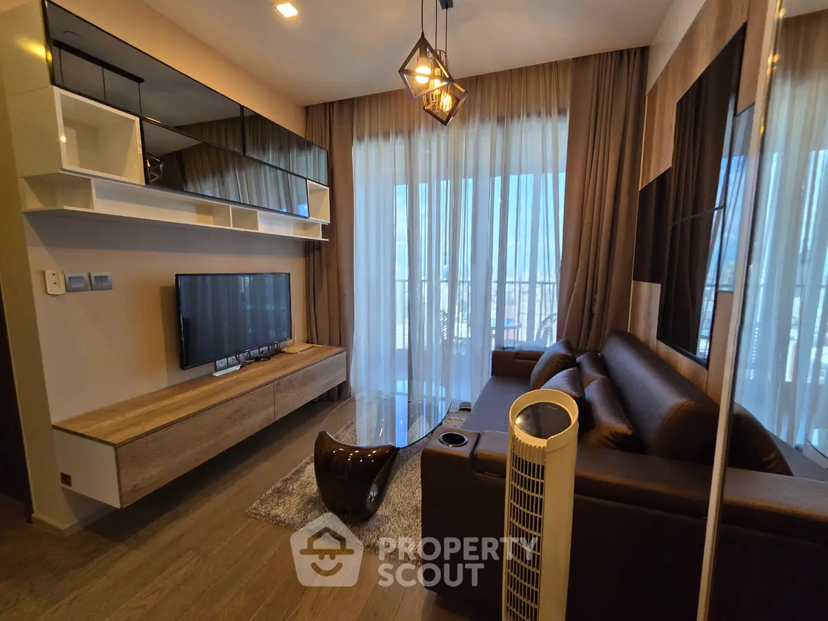 Modern living room with stylish decor and large windows offering natural light.