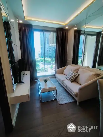 Modern living room with large windows and city view, featuring stylish furniture and elegant decor.