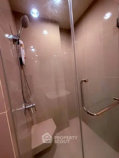 Modern bathroom with glass shower enclosure and sleek fixtures