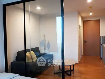 Modern apartment interior with glass partition and cozy living area