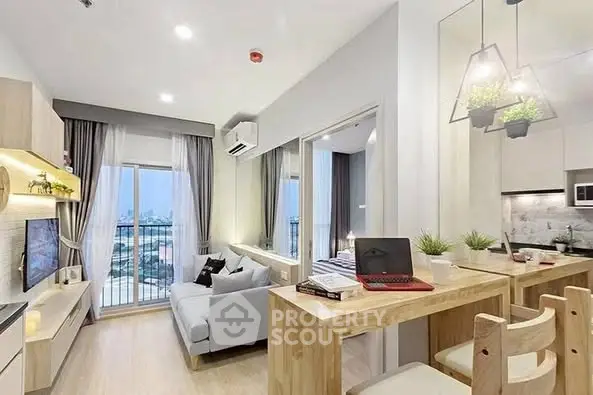 Modern open-plan living room with balcony and kitchen, featuring stylish decor and natural light.