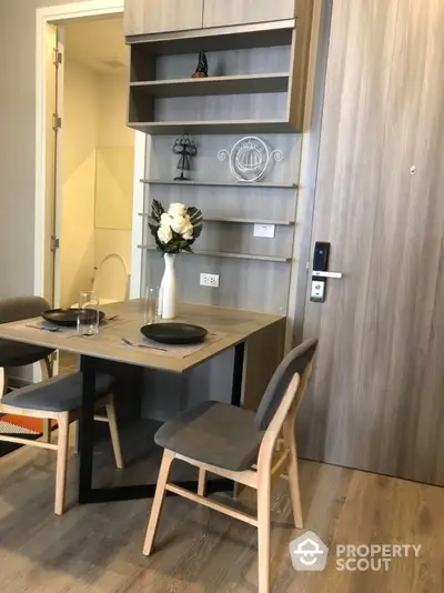 Modern dining area with stylish wooden furniture and elegant decor in a cozy apartment setting.