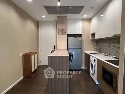 Modern kitchen with sleek appliances and stylish cabinetry in a compact layout.