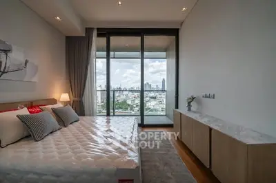 Luxurious bedroom with city view and spacious balcony access.