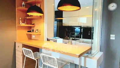 Modern kitchen with open layout and stylish breakfast bar in contemporary apartment.