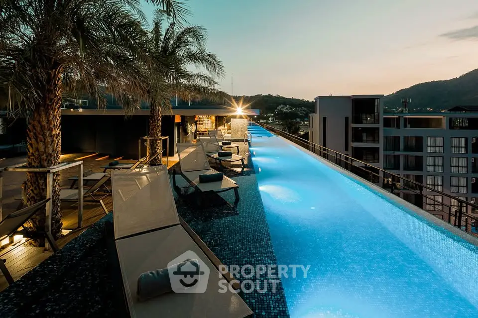 Luxurious rooftop infinity pool with stunning sunset view and modern lounge area.