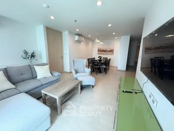 Spacious modern living room with elegant furniture and dining area, perfect for family gatherings.