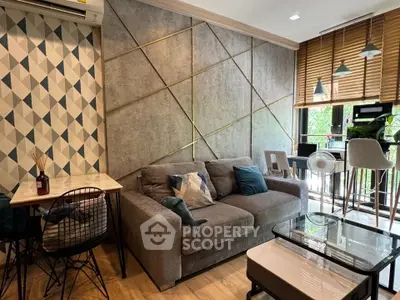 Stylish living room with modern decor and large windows in a contemporary apartment.