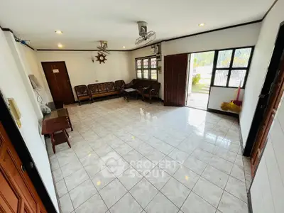 Spacious living room with tiled floor and ample natural light