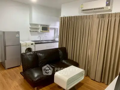 Modern studio apartment with sleek kitchen and cozy living area