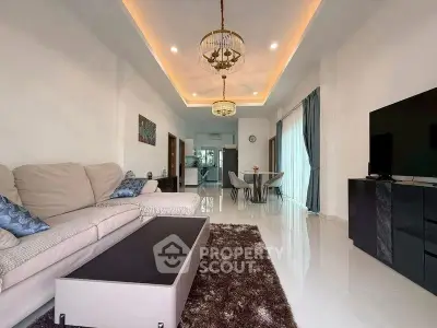 Spacious modern living room with elegant lighting and open layout, perfect for entertaining.