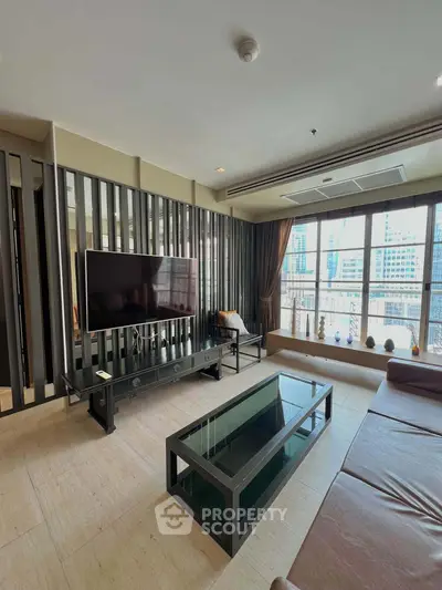 Spacious modern living room with large windows and city view