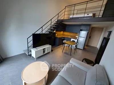 Modern loft apartment with mezzanine, sleek kitchen, and cozy living area.