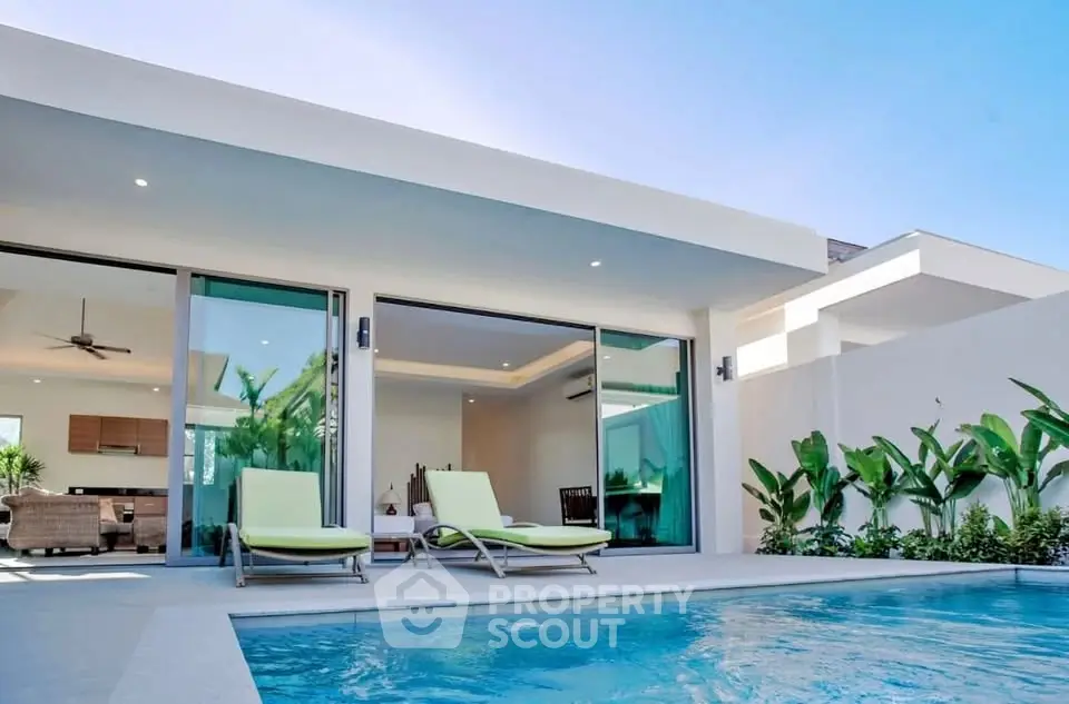 Luxurious modern villa with private pool and open living space, perfect for relaxation.