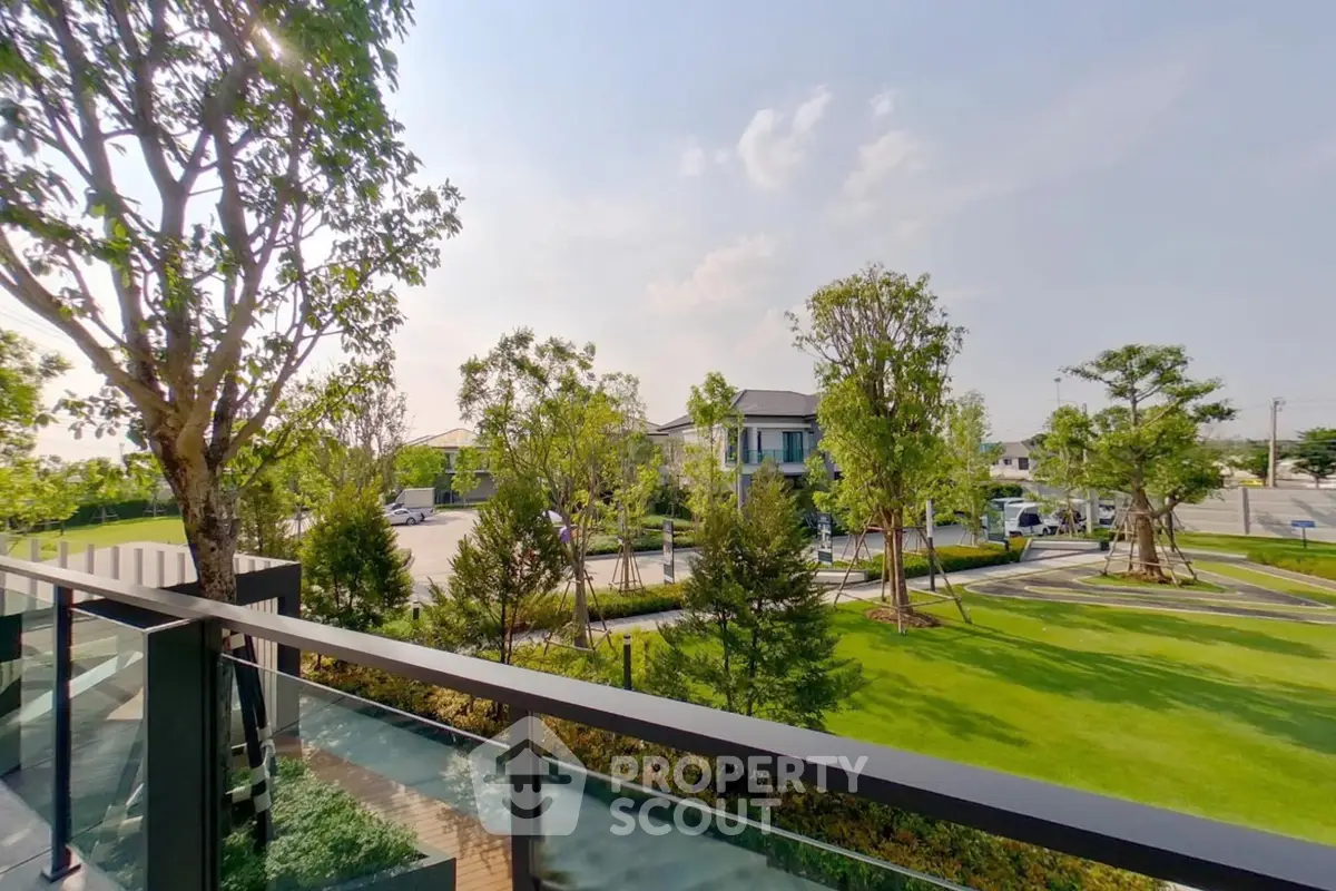 Stunning garden view from a modern balcony in a serene neighborhood.