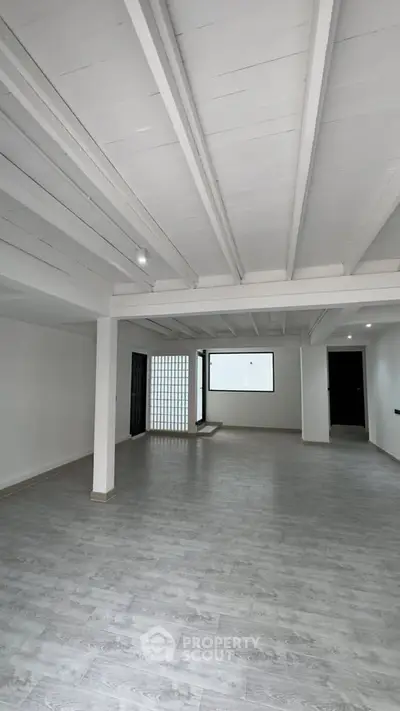 Spacious open-plan living area with modern design and natural light.