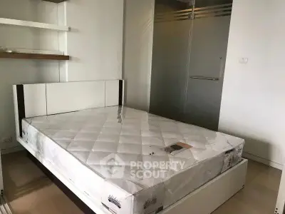 Modern bedroom with sleek design and comfortable mattress in a stylish apartment.