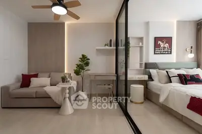 Modern studio apartment with stylish decor, featuring a cozy living area and comfortable bedroom separated by glass partition.
