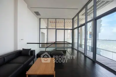 Luxurious modern living room with floor-to-ceiling windows and stunning city view.