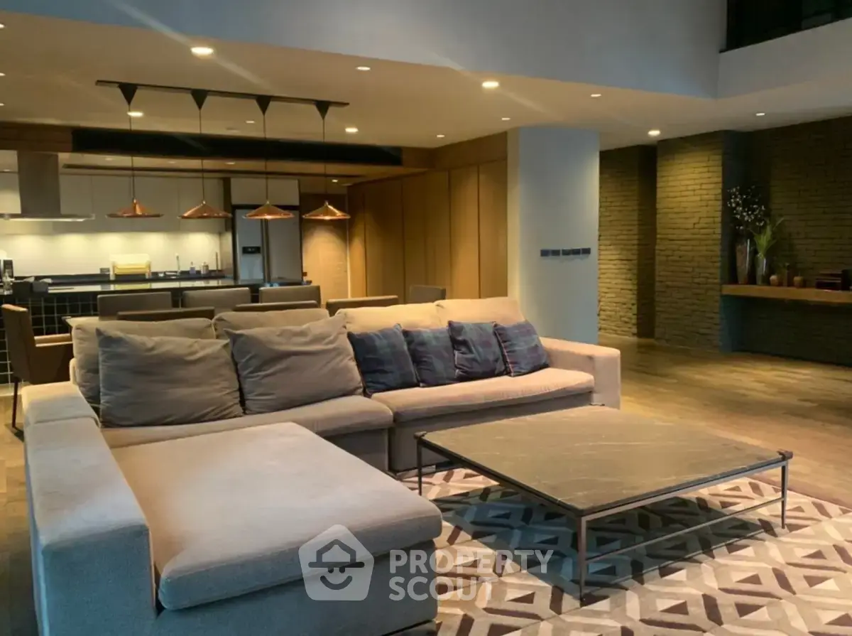 Spacious modern living room with stylish decor and open kitchen layout.