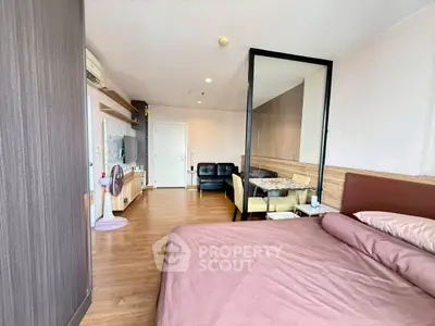 Spacious bedroom with modern decor and open layout in a stylish apartment.
