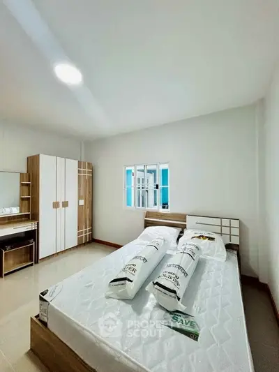 Spacious bedroom with modern furniture and ample natural light
