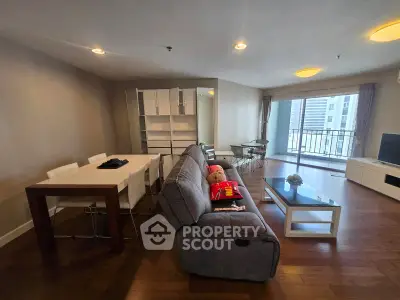 Spacious modern living room with balcony view in high-rise apartment