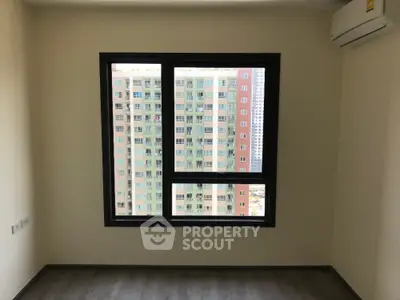 Modern apartment room with large window and city view