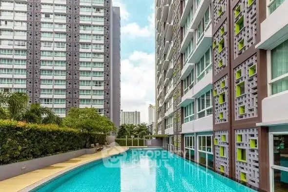 Modern condominium with stunning pool and lush greenery, perfect for urban living.