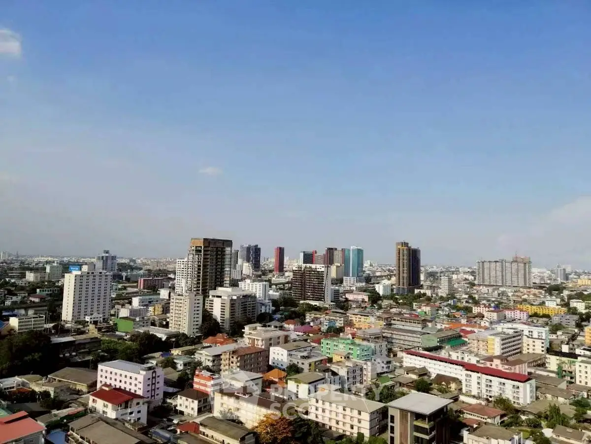 Stunning cityscape view showcasing vibrant urban skyline and diverse architecture under clear blue skies.